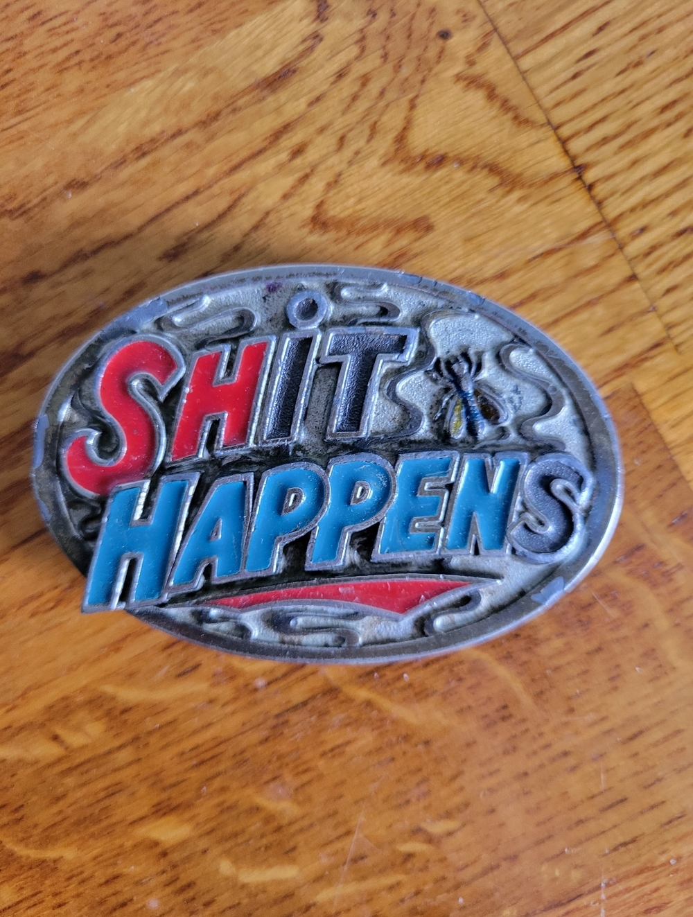 "Shit Happens" Oval Enamel Belt Buckle - Red & Blue